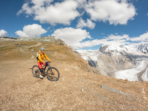 istock Mountain biker on dirt trail along beautiful glacier, Switzerland 1494817711