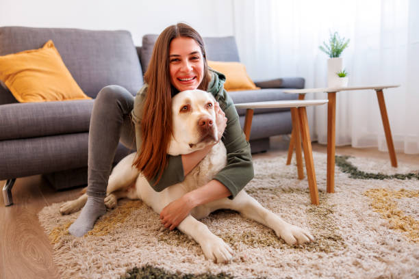 istock Woman cuddling and hugging her pet dog 1494817758