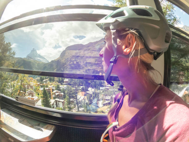 istock Mountain biker looks out of sunny train window, Matterhorn view 1494817774
