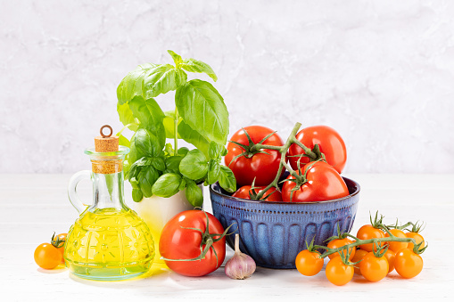 Ingredients for cooking. Italian cuisine. Tomatoes, olive oil, basil. With copy space