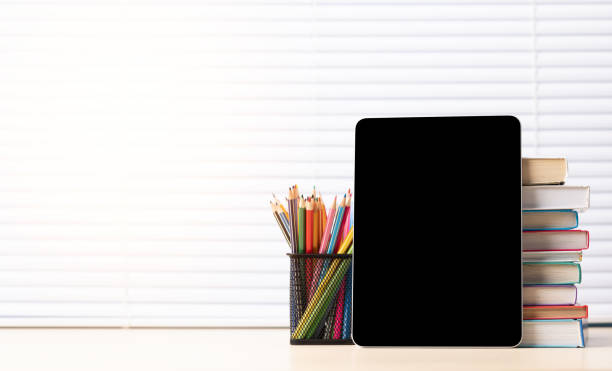 istock Tablet with colorful pencils and stack of books 1494819467