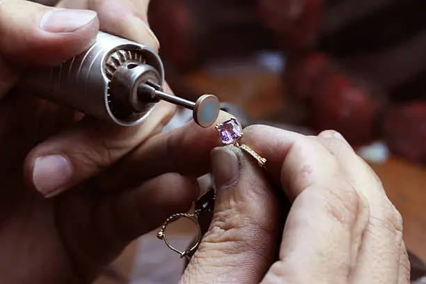 Close up of repairing ring by polishing motors tool