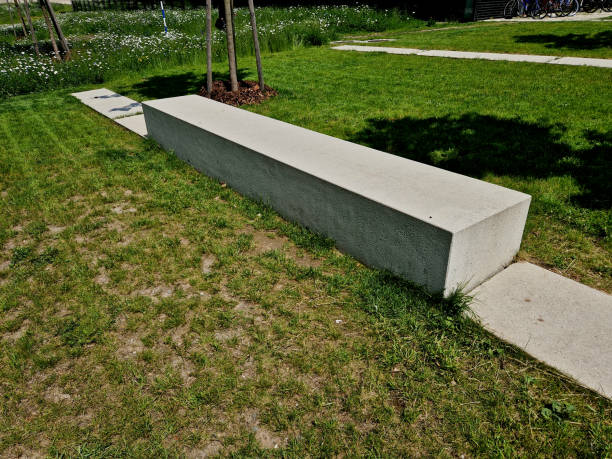 istock concrete white bench block and wave shape in the park on a dark cobbled square, clean concrete surface gray brown white pedestrian and rest area at the skate park for young people, teenagers 1494821066