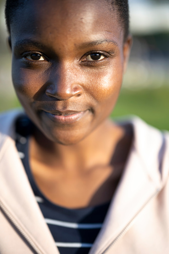 Portrait of an young African girl with a slight smile outdoors on a sunny day