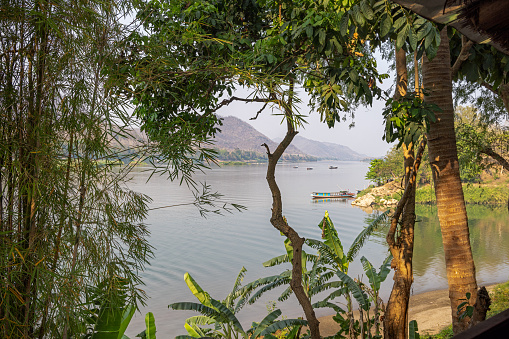 Mekong River, Luang Prabang, Laos - March 15th 2023: View up the river with tour boats making ready for the sunset business