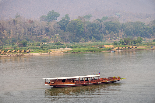 Mekong River, Luang Prabang, Laos - March 11th 2023: The tourboats are primary used for either taking tourists up and down the river or taking the local people to the villages in the neighbor hood from the the former capital of Laos