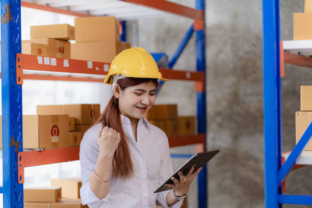 istock Asian businesswoman using laptop computer checking customer orders online at home. Starting a small business SME. independent entrepreneur Online business, parcel delivery concept 1494831499