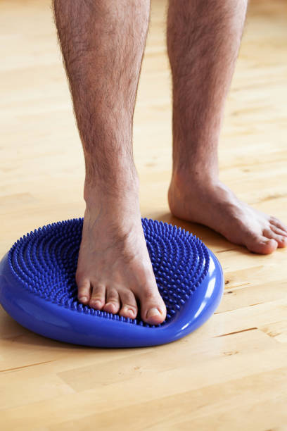 istock man doing flatfoot correction gymnastic exercise balancing on massage cushion at home 1494831775