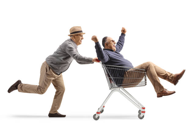 istock Senior man riding a man inside a shopping cart 1494831862