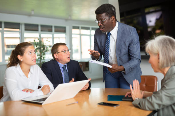 istock Angry middle-aged man shouting at his business partners sitting around table 1494833441