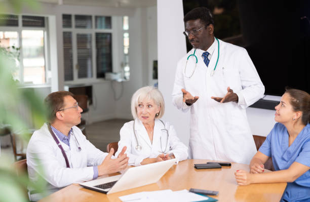 istock Group of different people medics having discussion at table 1494833977