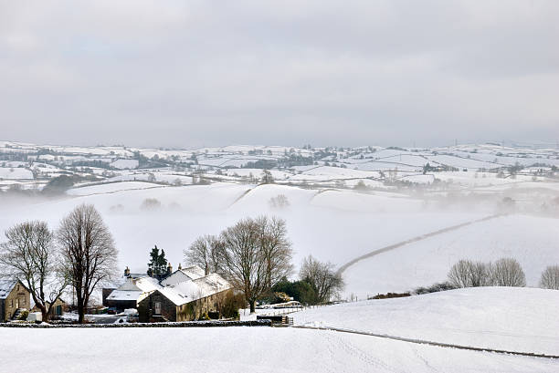 istock Small Farmhouse in Snow Covered Hills 149483644