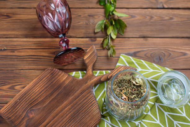 istock Decorative cutting board for cooking. Spices in a glass jar 1494836724