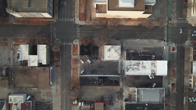 Birds eye view looking down on Lincoln, NE buildings and empty parking lots