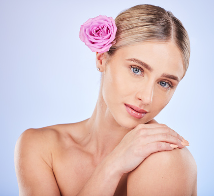 Beauty, skincare and rose with portrait of woman for self care, natural cosmetics and glow. Spring, spa and facial treatment with girl model and flowers for blossom, organic and plants in studio