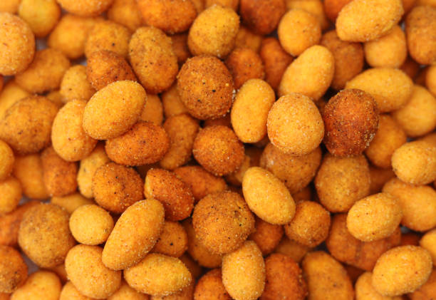 istock Spicy sauce coated peanuts backdrop pattern background. Hot paprika snack appetizer 1494842156
