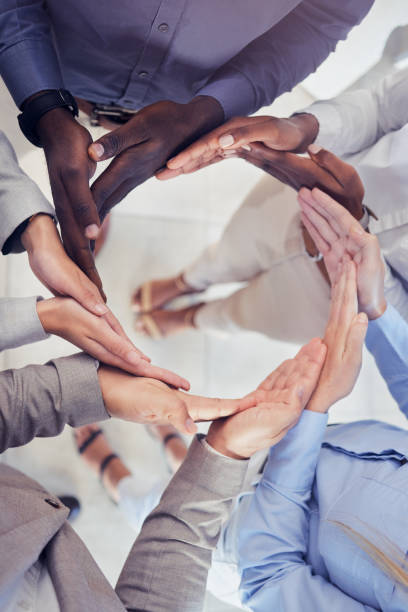 istock Hands, collaboration and workflow with a business team standing in a circle at the office from above. Meeting, partnership and teamwork with a group of people in a huddle for growth or synergy 1494842973