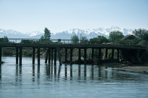 Bridge across the river with mountain ridge on background