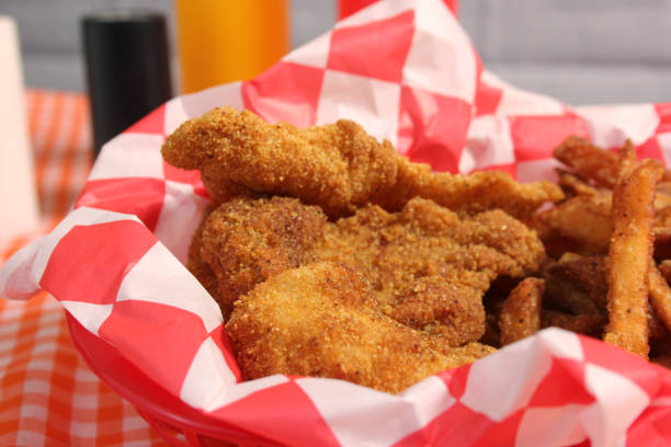 istock Fried Catfish Basket With French Fries in Rustic Cafe 1494847825