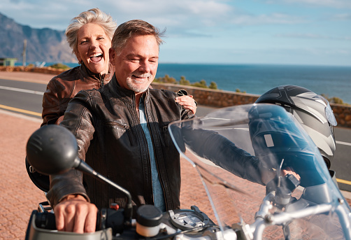 Travel, mountain and senior couple on motorcycle for adventure, freedom and road trip in retirement. Adrenaline, travelling and happy man and woman ride on motorbike for holiday, vacation and journey