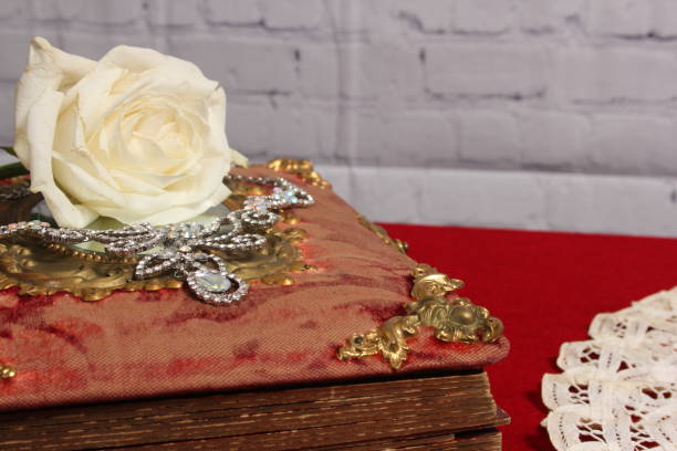 istock White Rose on Antique Book With Crystal Rhinestone Necklace 1494851155