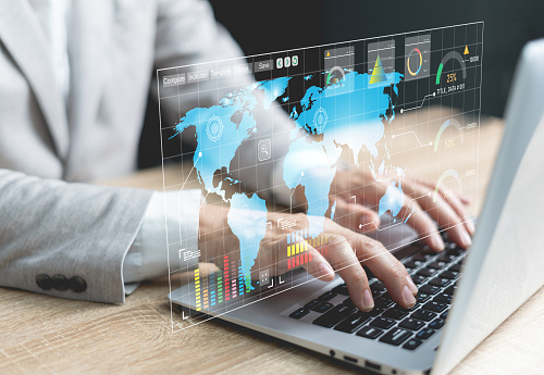 Businessman analyzing data working on a dashboard. Business analytics with charts, metrics, and KPIs to improve organizational performance, marketing, and strategy.