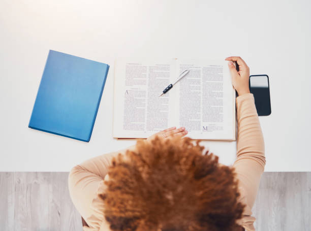 istock Student, notebook and studying in a library for university exam, test and book report. From above, college female and reading notes of a learning young person with education books for knowledge 1494853759
