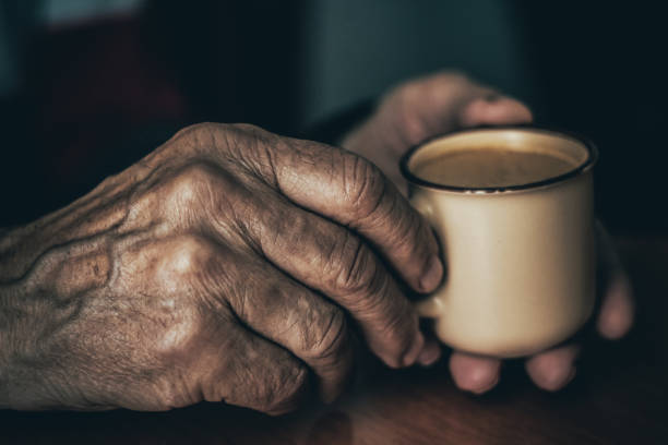 istock Anonymous senior person holding coffee cup in hands 1494854348