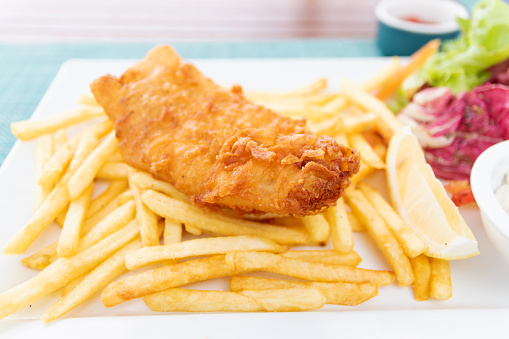 Fish and chips; deep fried fish filet and crispy french fries served with tarter sauce.