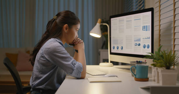 istock Asia people young woman study hard overnight brownout bored remote learn online read data tired sitting head in hands at home office desk workplace think worry in job tough stress workforce issue. 1494856880