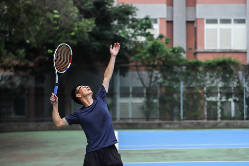 asian tennis player is playing on tennis court