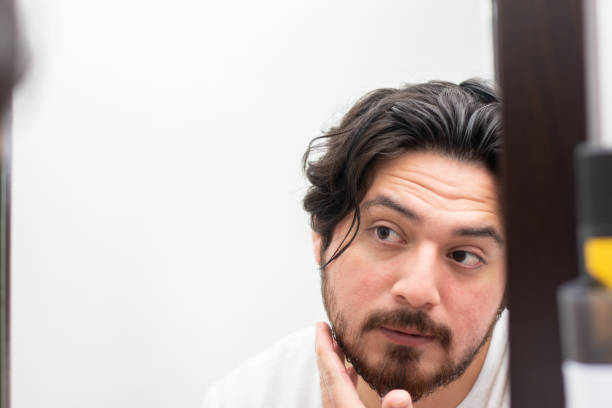 istock Reflection of man touching his beard while he are looking in mirror with copy space 1494861404