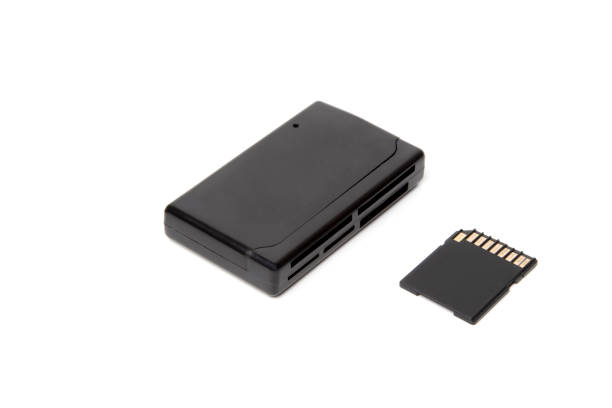 istock Top view, the adapter, the card reader is rectangular, black for all types of flash cards and storage devices. With a black flash card nearby. For transferring data from mini cd. On a white isolated 1494865110