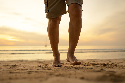 men's footsteps on the sandy beach
