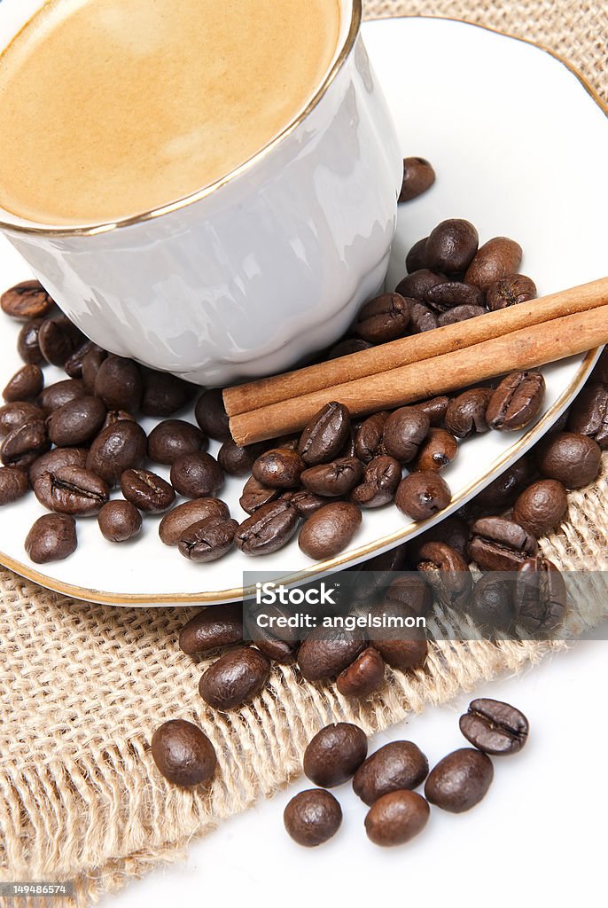 Coffee and cinnamon sticks. Still life about coffee with a delicious  espresso and some coffee beans and cinnamon. Above Stock Photo