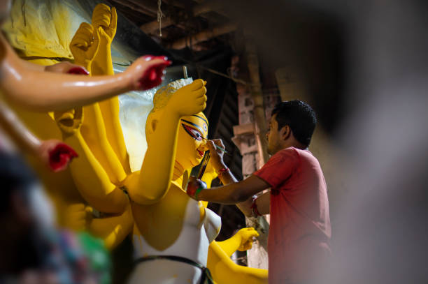 Artist making hindu god durga devi at Kumortuli