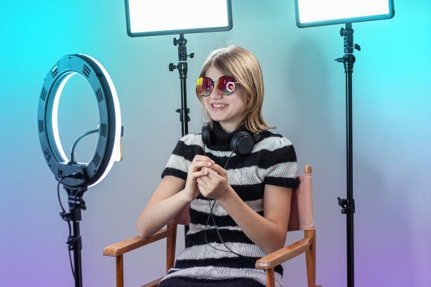 istock Influencer blogger girl making a video with a ring light 1494869403