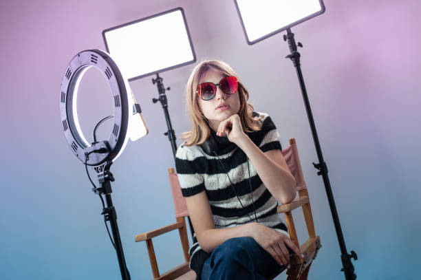 istock Influencer blogger girl making a video with a ring light 1494869413