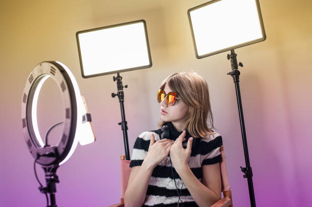 istock Influencer blogger girl making a video with a ring light 1494869427