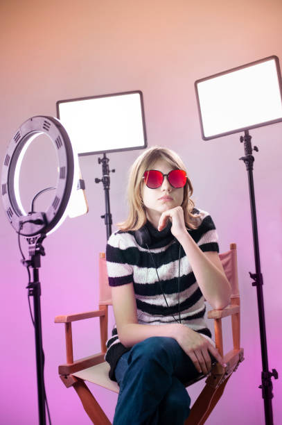 istock Influencer blogger girl making a video with a ring light 1494869441
