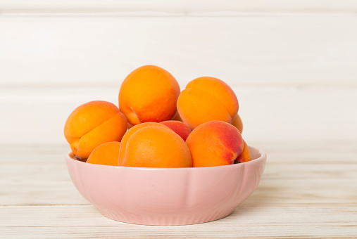 Composition with ripe apricots on wooden background, top view.