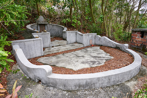 An old tomb in the open-air cemetery in the outskirts of Tai o Village. Lantau Island. Hong Kong S.A.R. China.