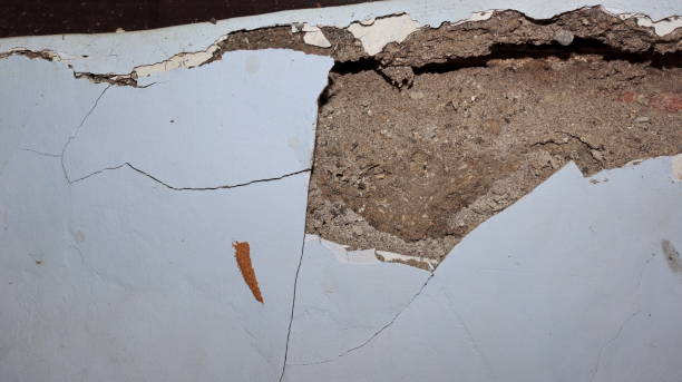 istock Cement wall collapse. Cracked concrete old wall. dangerous, damaged building structure. 1494871260