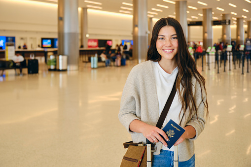 A young woman traveler in a public airport.