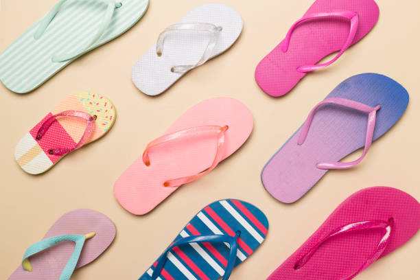 istock Many colorful flip flops on color background, top view 1494873107