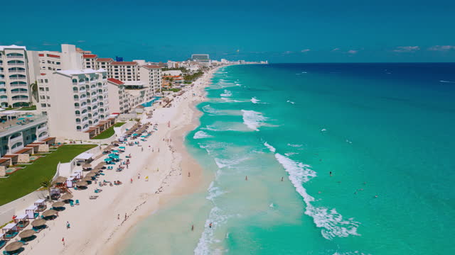 Aerial shot along Cancun coastline and luxury hotels in Mexico