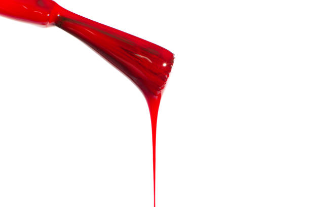istock Red dripping nail polish brush. On a white background 1494873546