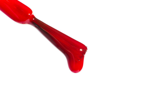 Red dripping nail polish brush. On a white background