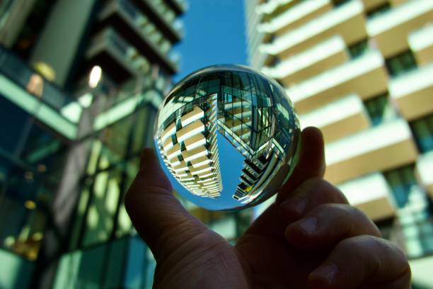 istock Hand holding crystal ball against modern buildings 1494879350