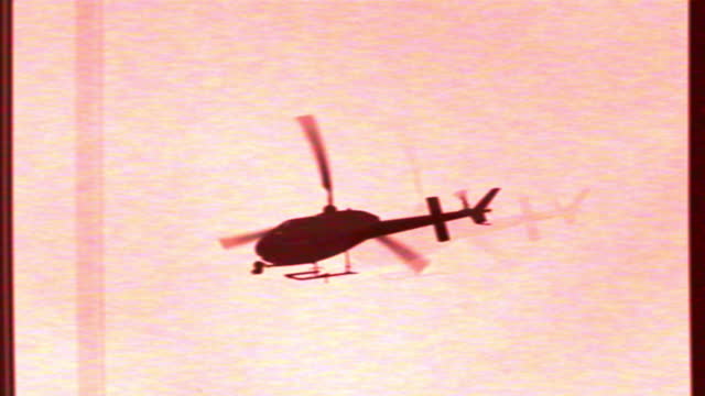 Helicopter flying in the red sky